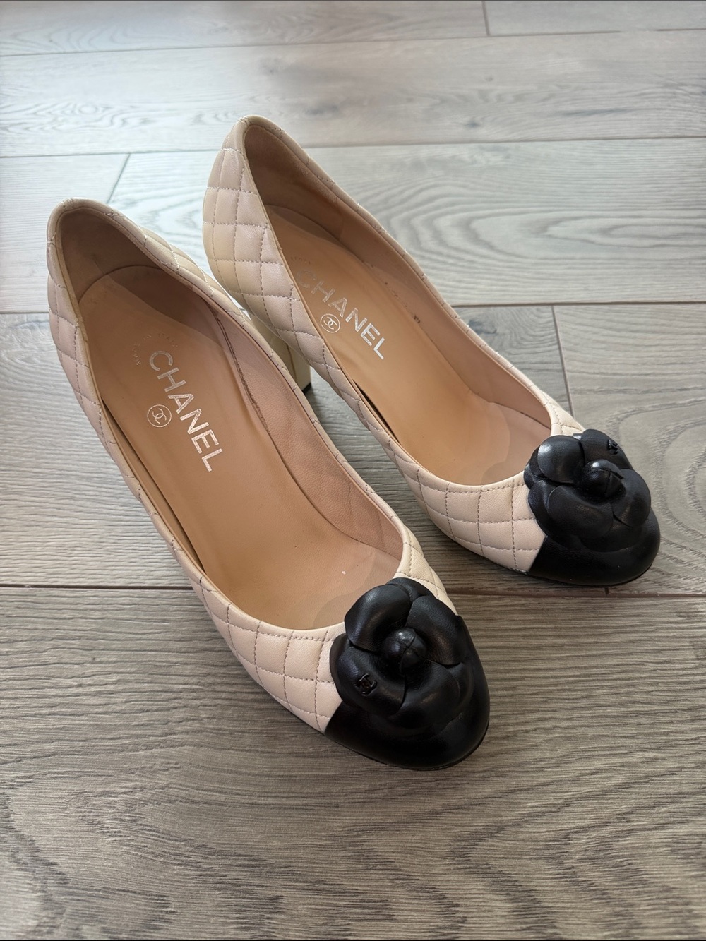 CHANEL Quilted Camellia Cap-Toe Pumps in Cream and Black